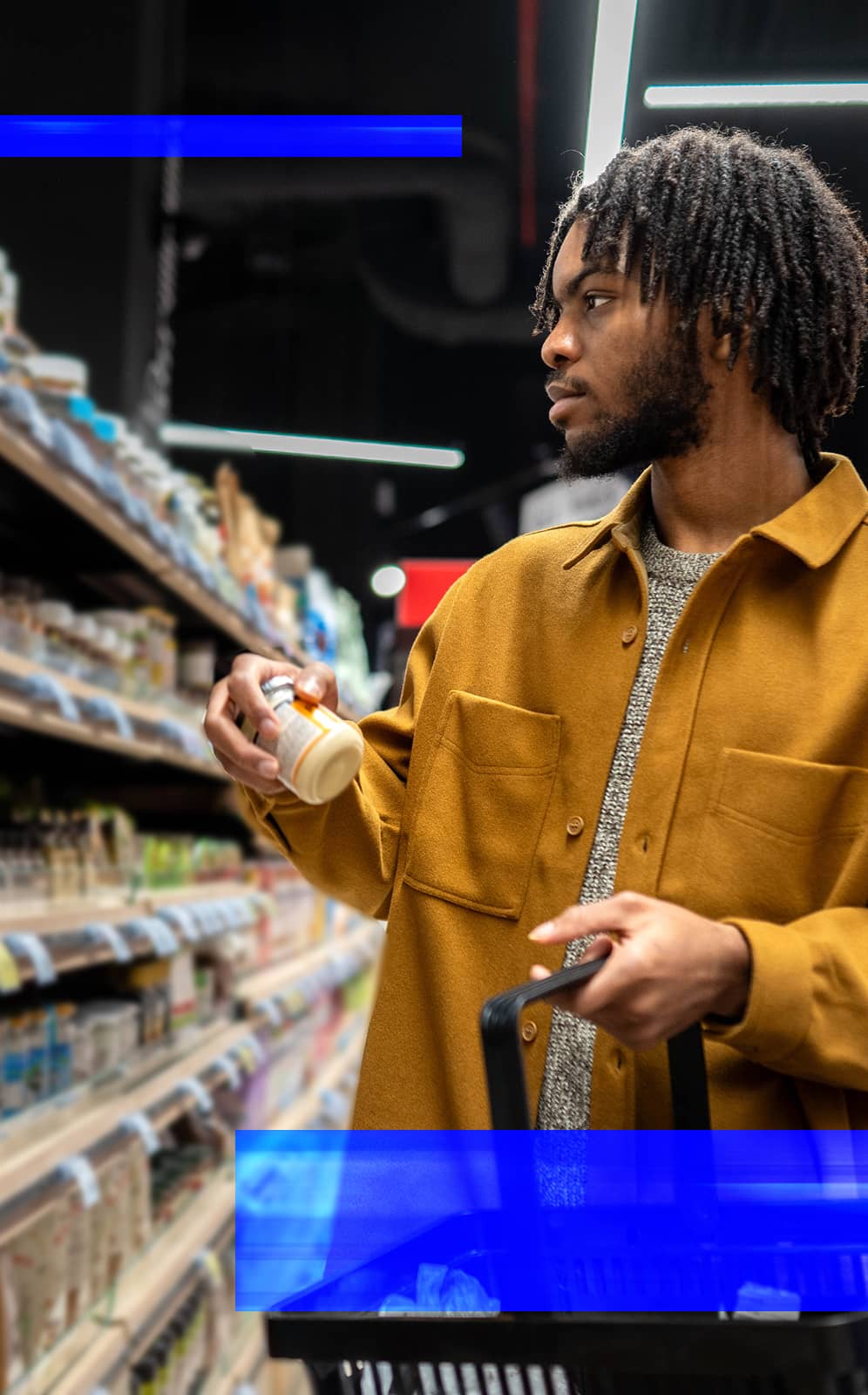 Shopper reviewing a packaged product in a retail store aisle before making a purchase.