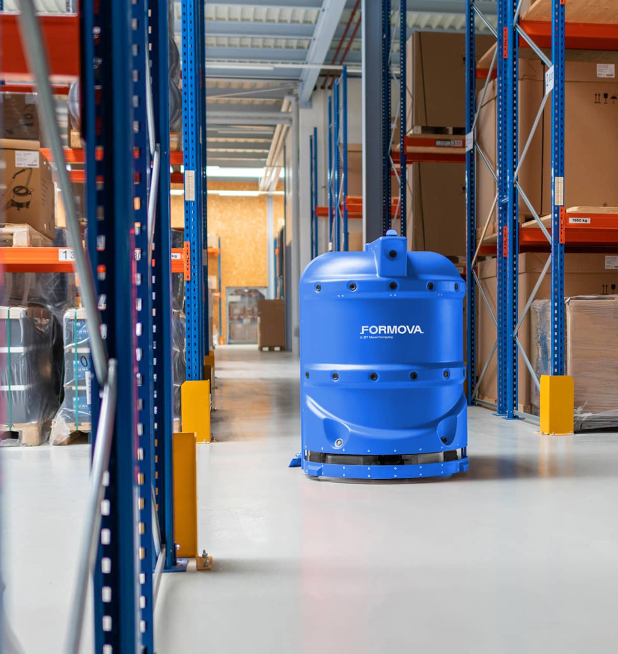 A blue Formova Floor Scrubber automated guided vehicle (agv) operates in a warehouse aisle