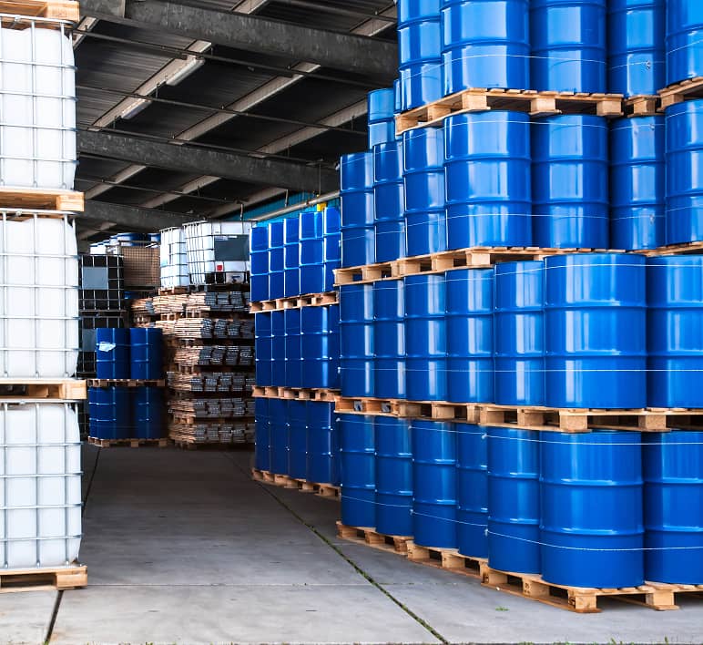 A warehouse interior with high-bay storage racks and palletized inventory.