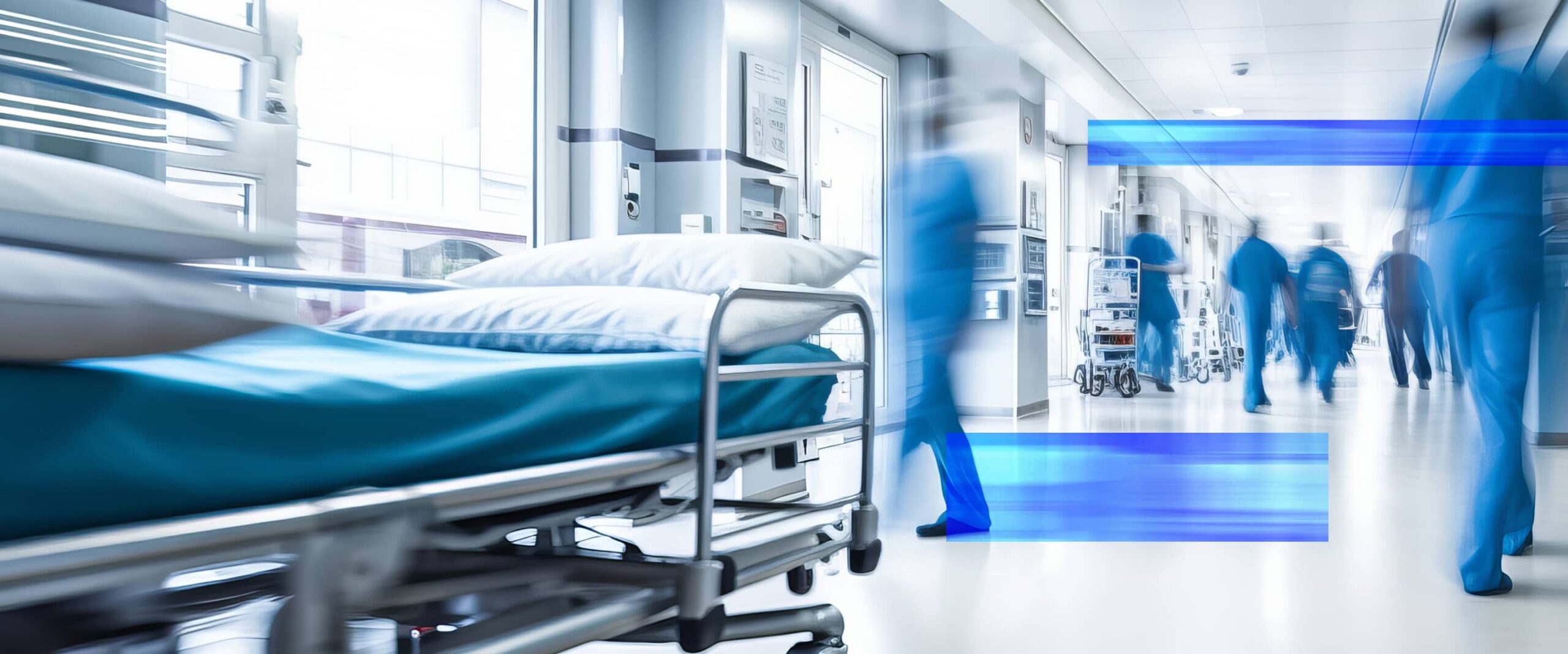 Le personnel hospitalier se déplace dans un couloir très fréquenté de l'établissement, à côté du lit d'un patient.