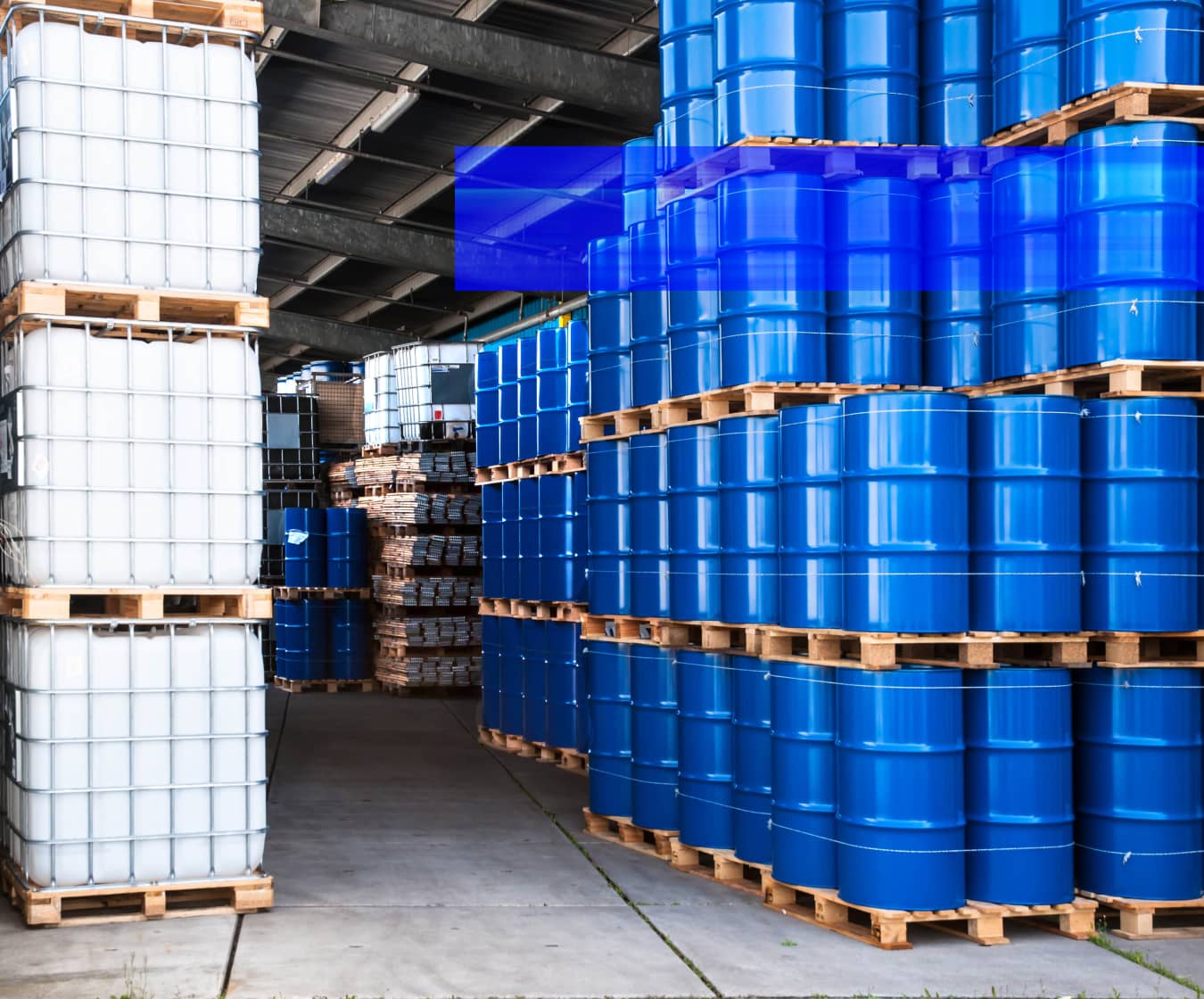 A warehouse interior with high-bay storage racks and palletized inventory.