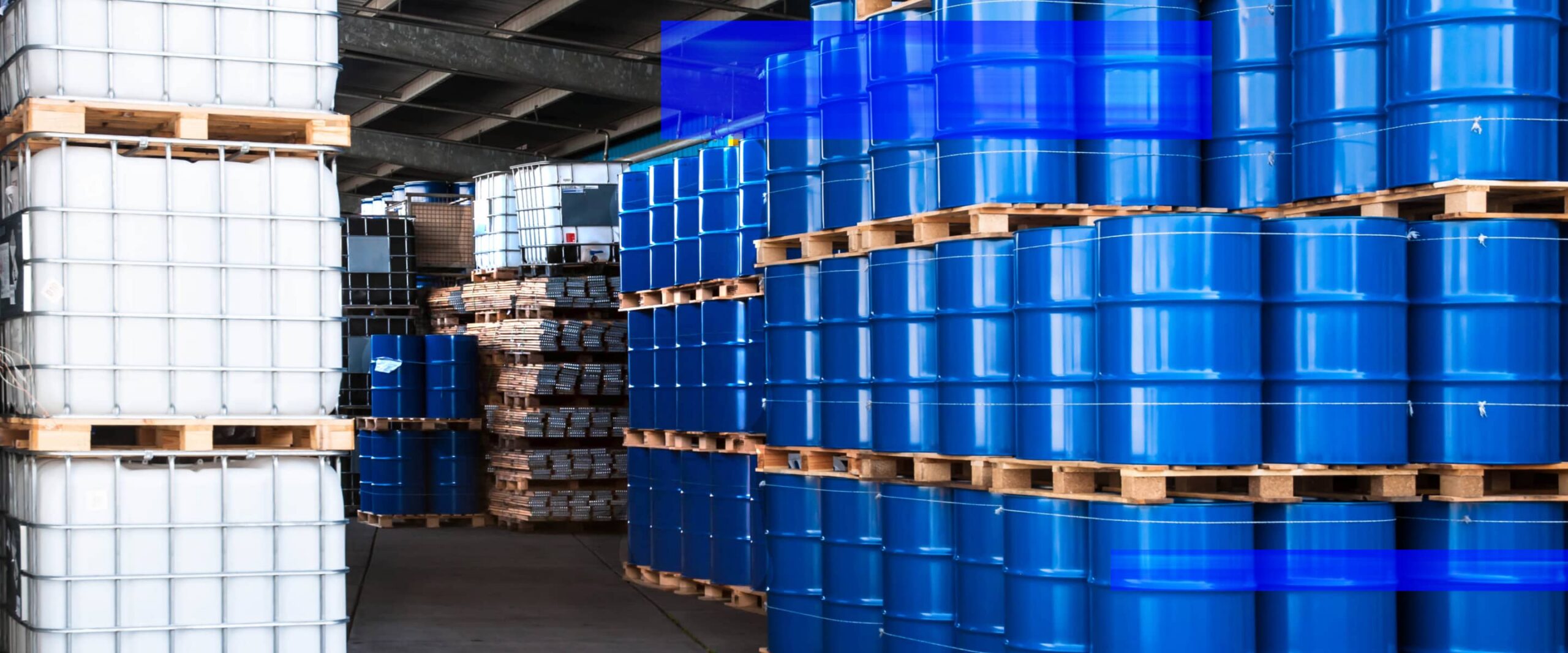 A warehouse interior with high-bay storage racks and palletized inventory.