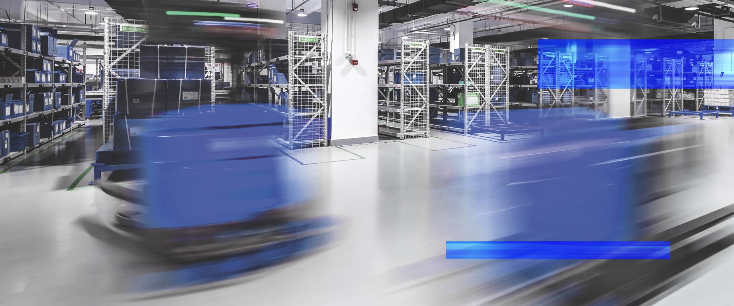Automated guided vehicles move through a warehouse fulfillment area.
