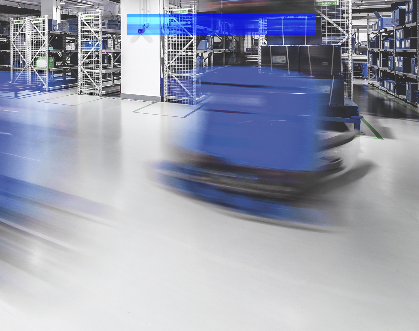 Automated guided vehicles move through a warehouse fulfillment area.