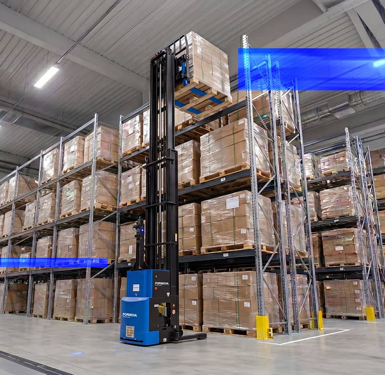 A Formova reach automated guided vehicle (agv) lifts a pallet to a high storage rack position